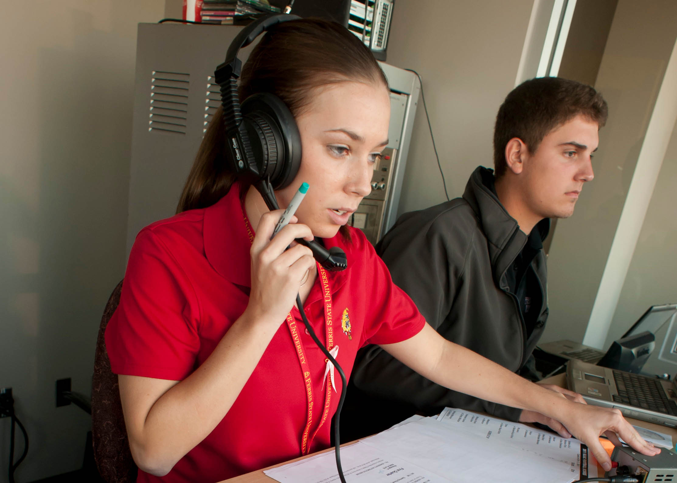 student in an announcer's booth working