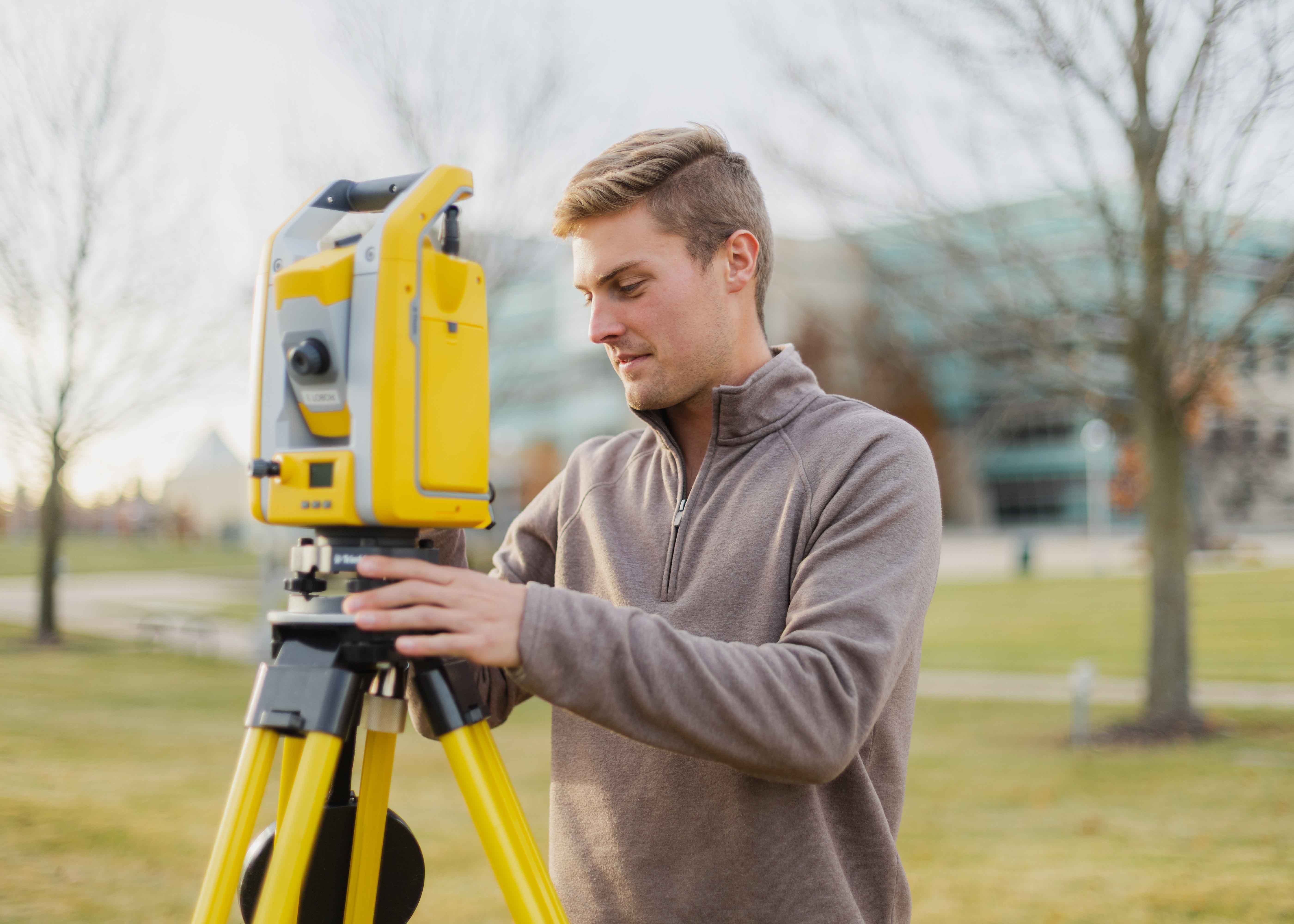 Student using surveying equipment