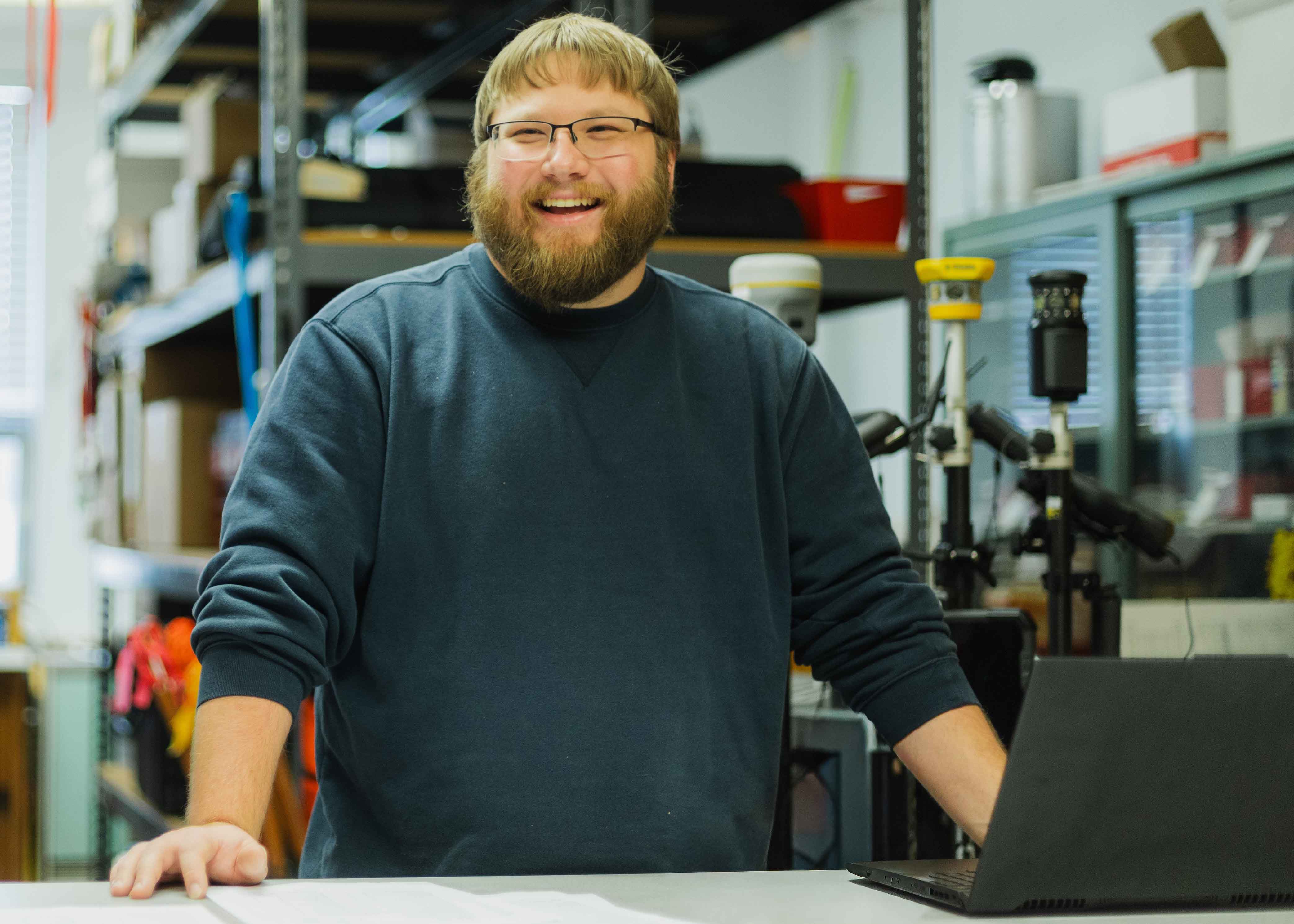 student in supply room for surveying engineering equipment