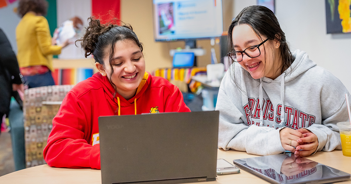 Ferris State University international students working on a laptop.