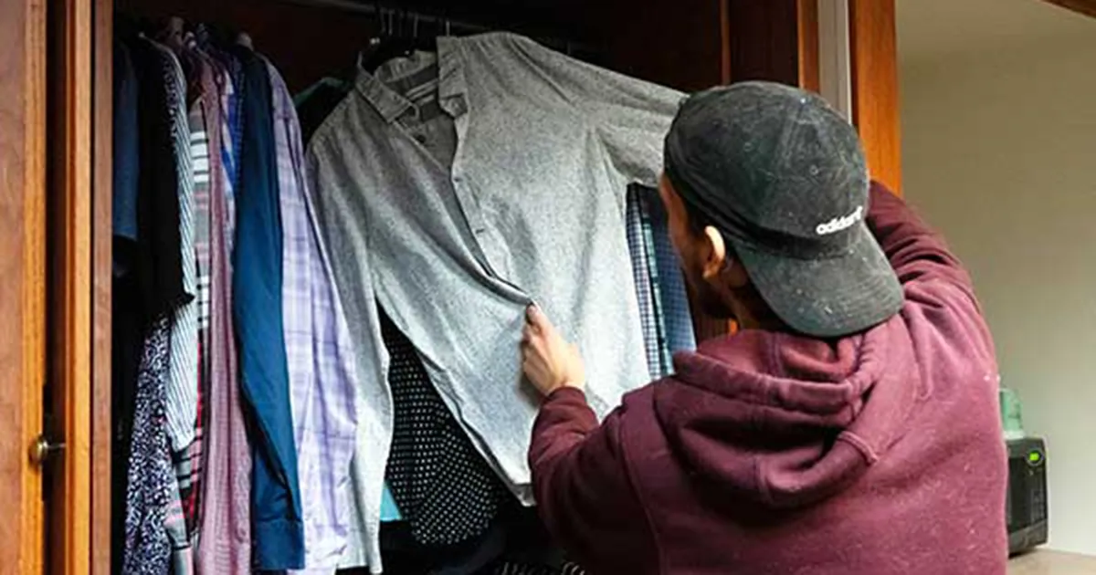 student getting clothing from stash