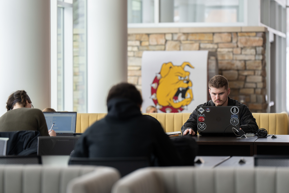 A student working with a computer on the campus of Ferris State University in Big Rapids MI