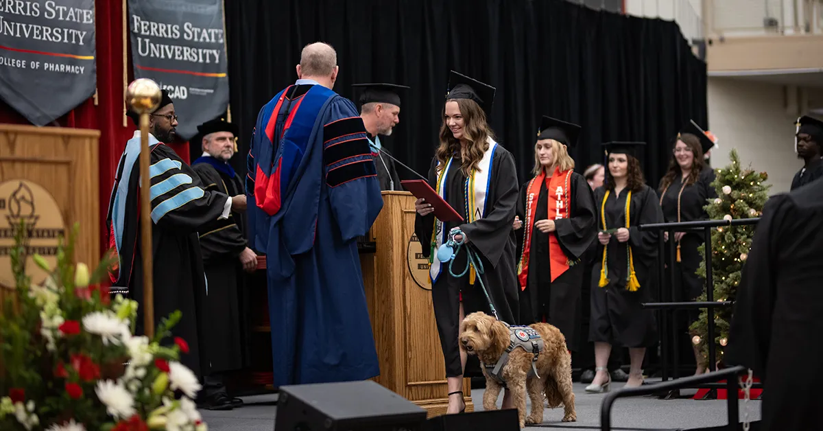 Layla the service dog helps Ferris State student Lily DeGroot overcome challenges – right through to commencement