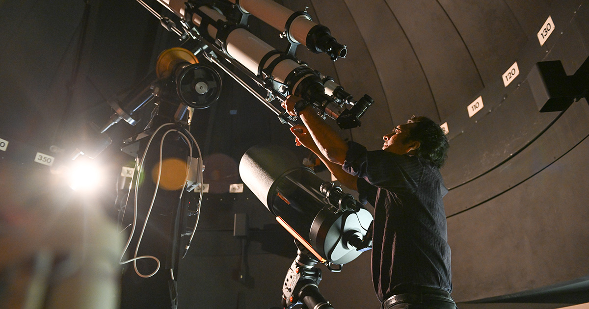 person using a telescope