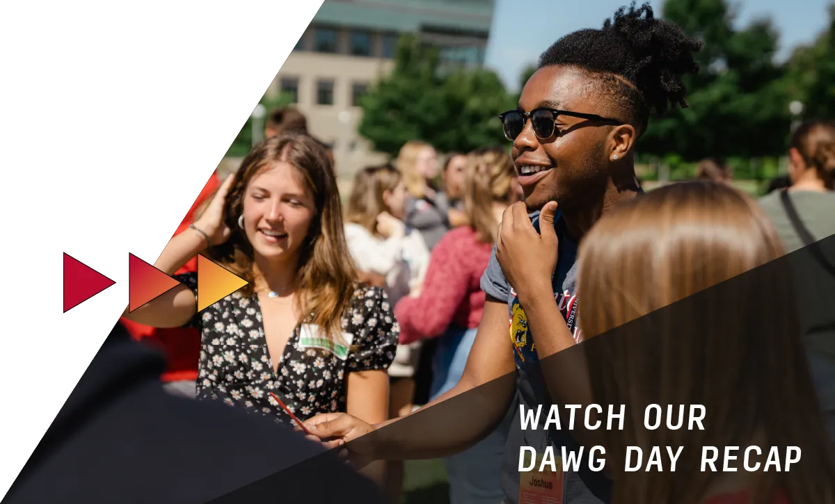 Students having fun at an outdoor event on the campus of Ferris State University. A text overlay reads "Watch our Dawg Day Recap"