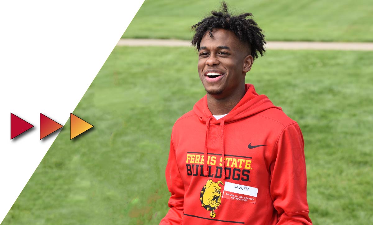 Student in smiling in the Quad at Ferris State University