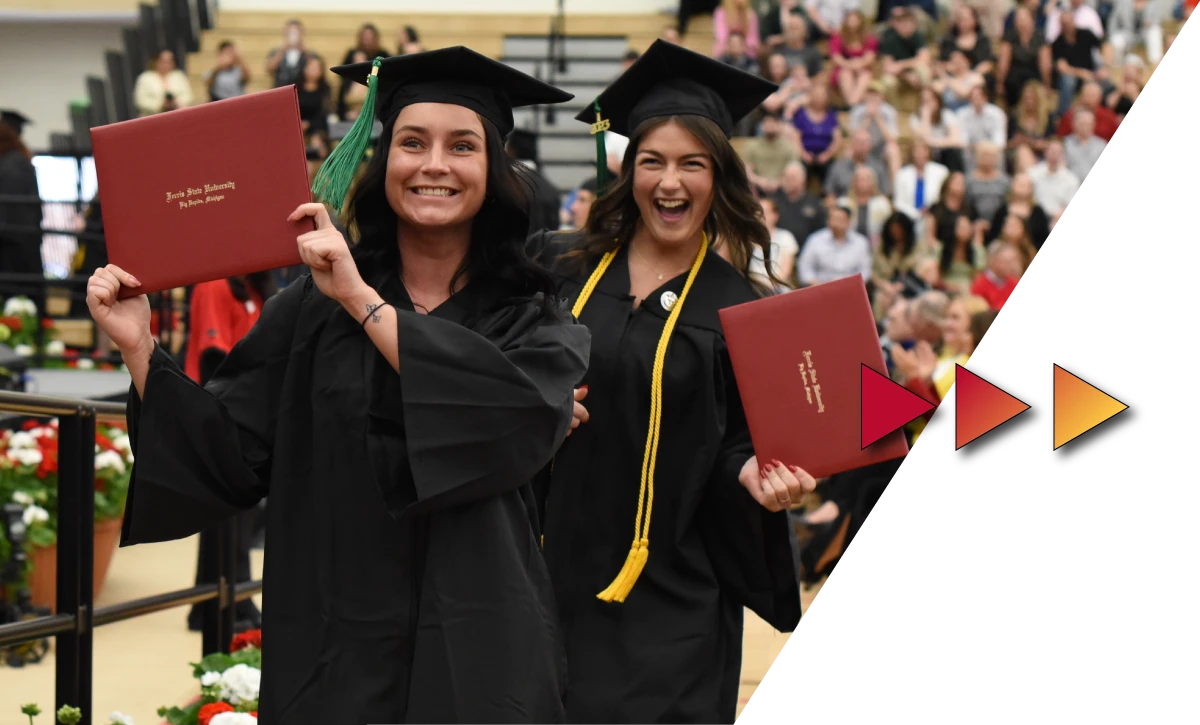 Ferris State students graduating at commencement with their diplomas 