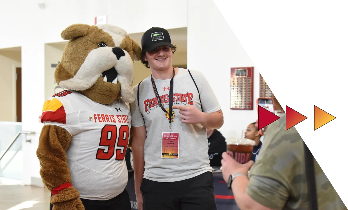 Student posing with Brutus Bulldog, the Ferris State University mascot