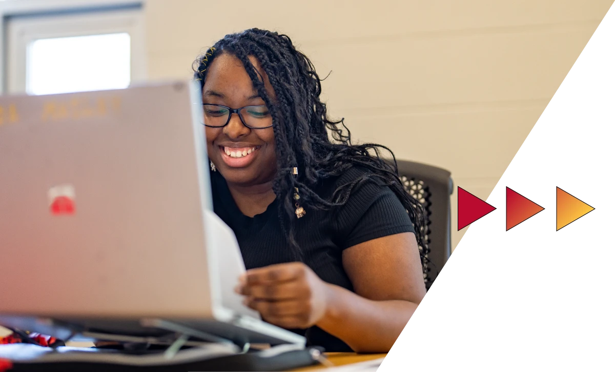 Student working with a computer on Ferris State University's campus in Big Rapids, MI