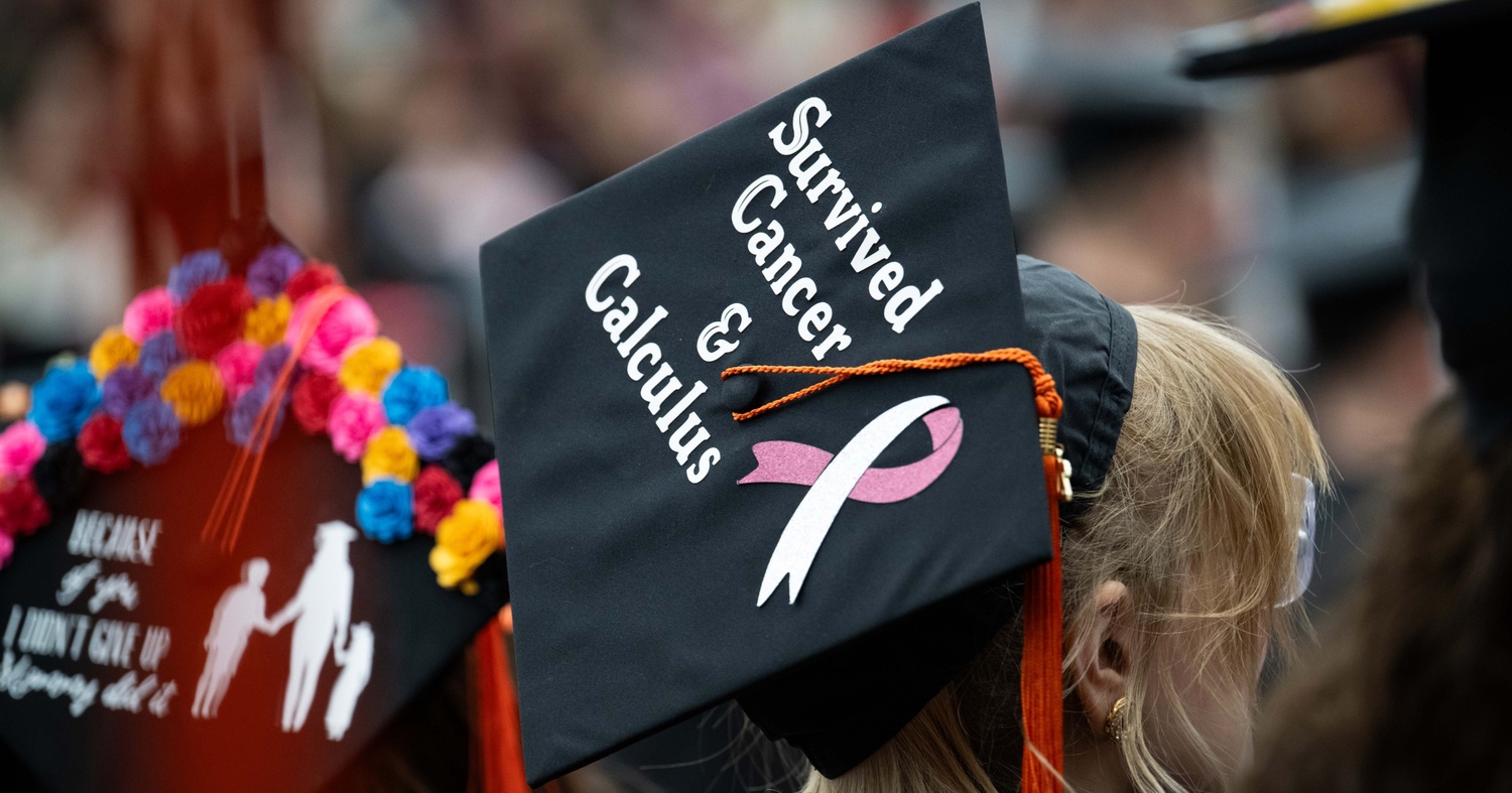 A photo of Baade's mortarboard graduation cap reading: "Survived cancer and calculus"
