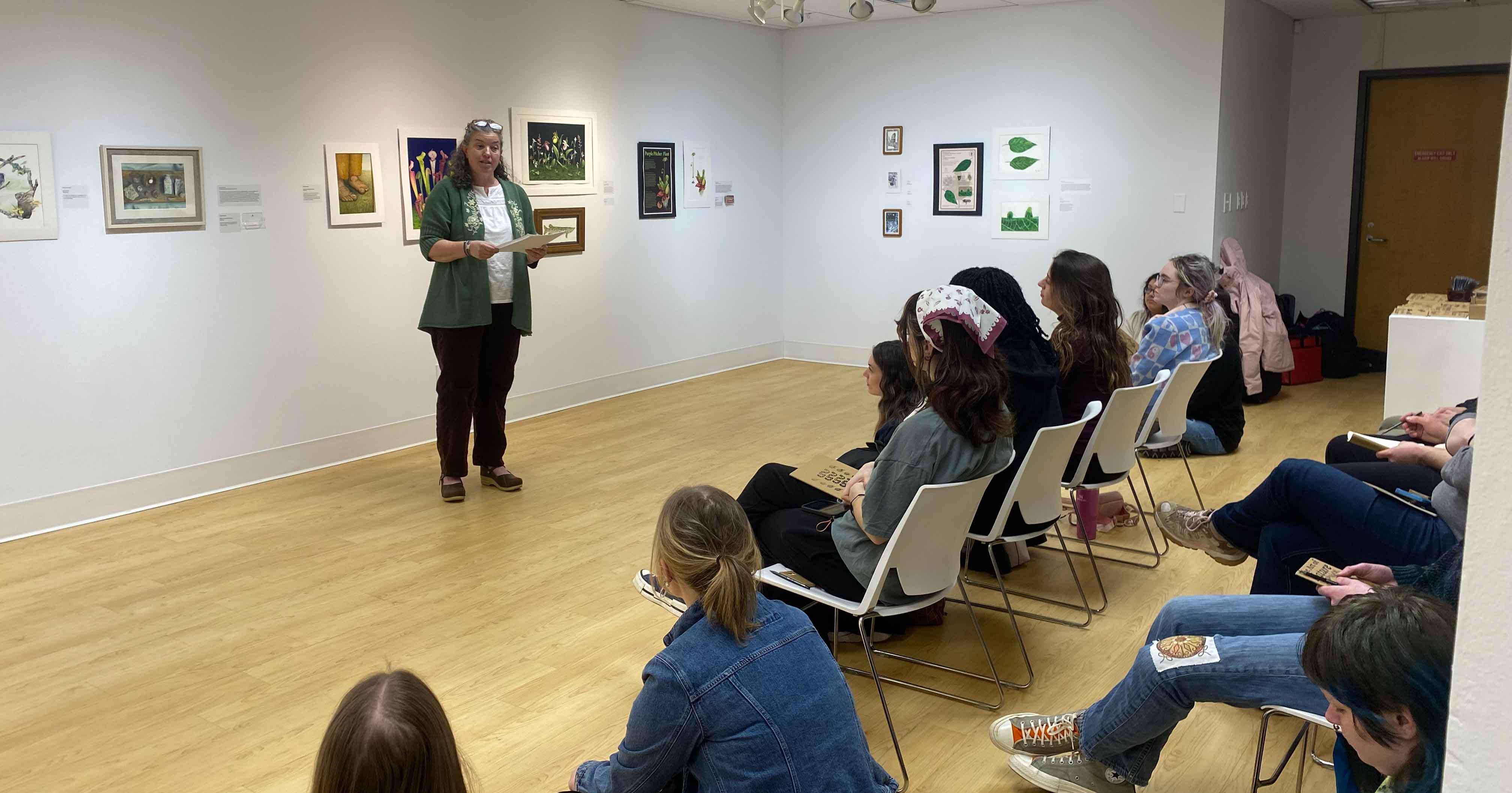 Students and attendees listen to a special speaker inside the gallery.