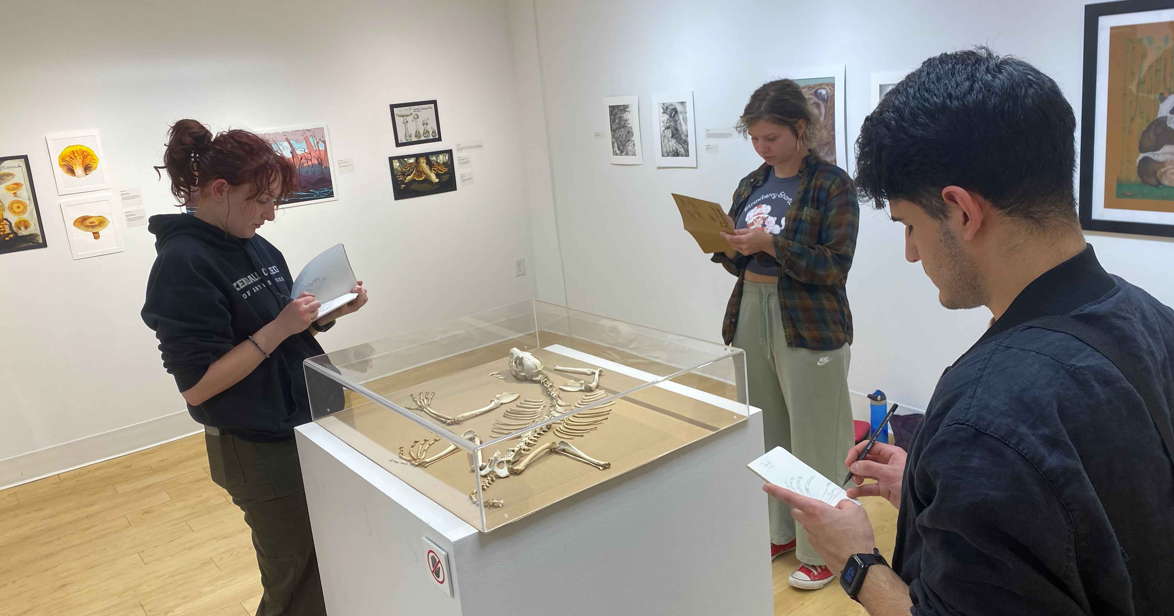 Students sketching in the gallery.