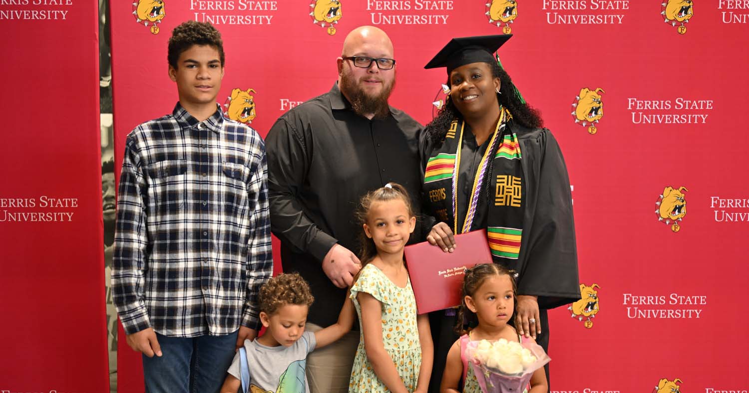 Beach standing with her family following her graduation ceremony