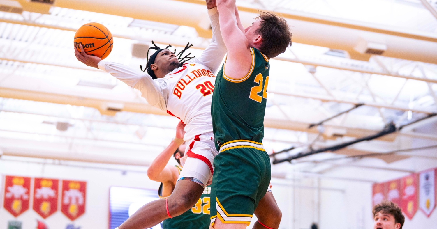Tae Boyd attempting an off-balance shot over a Northern Michigan defender