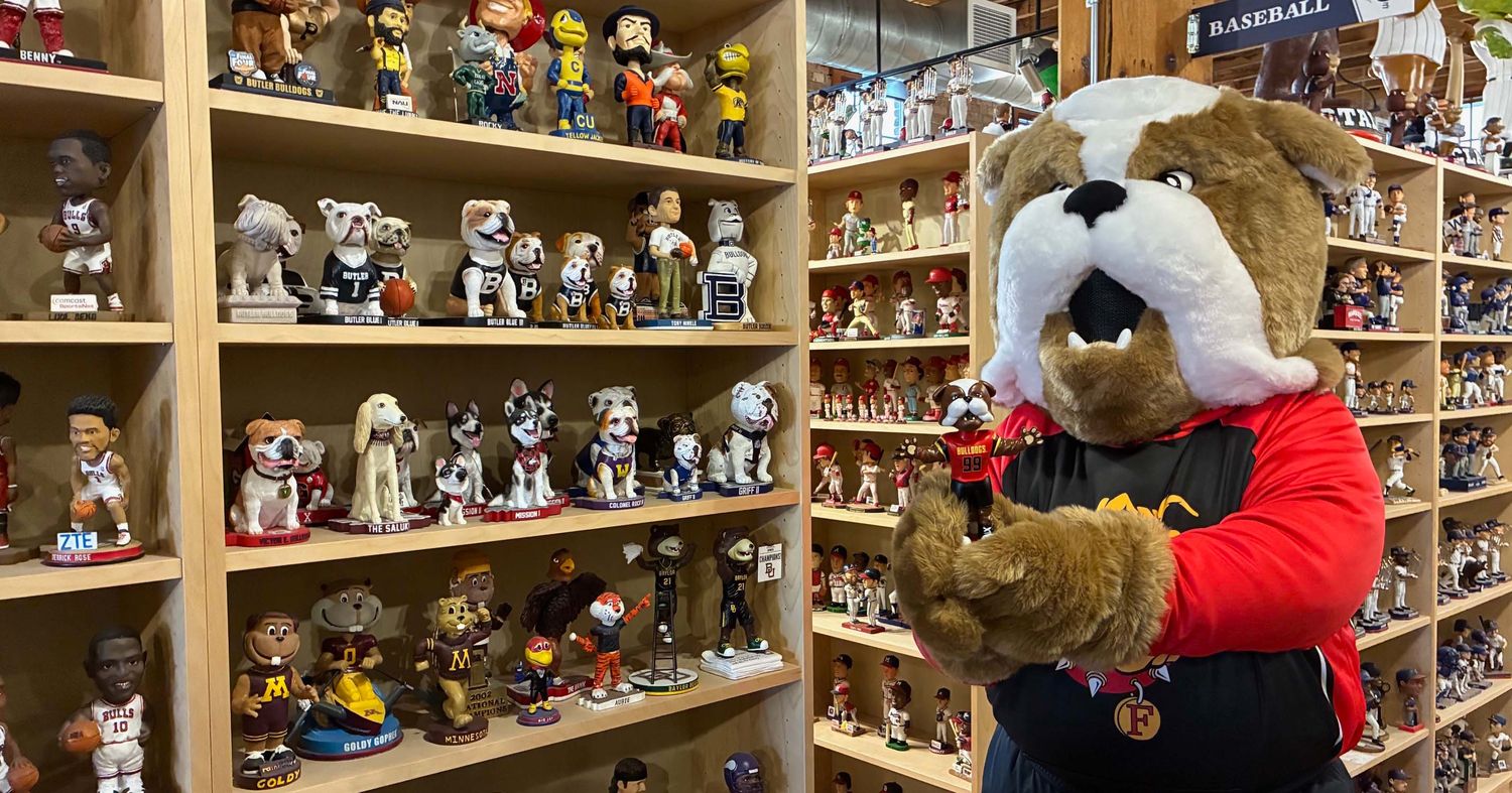 Brutus posing in front of the other collegiate mascot bobbleheads already on display