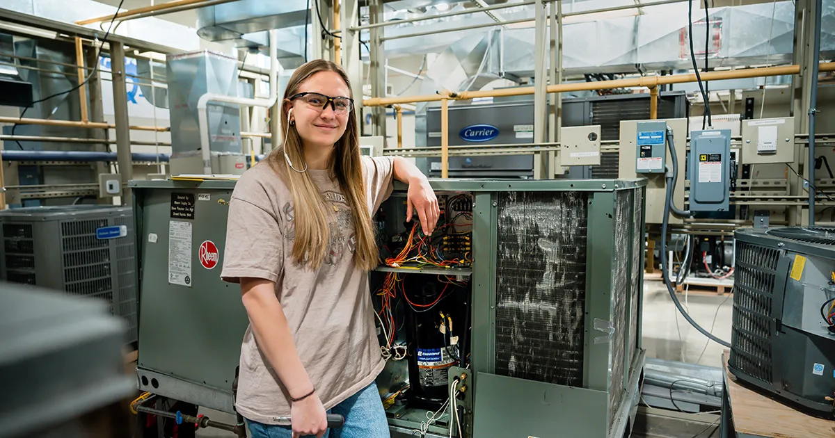 Student in front of electrical unit