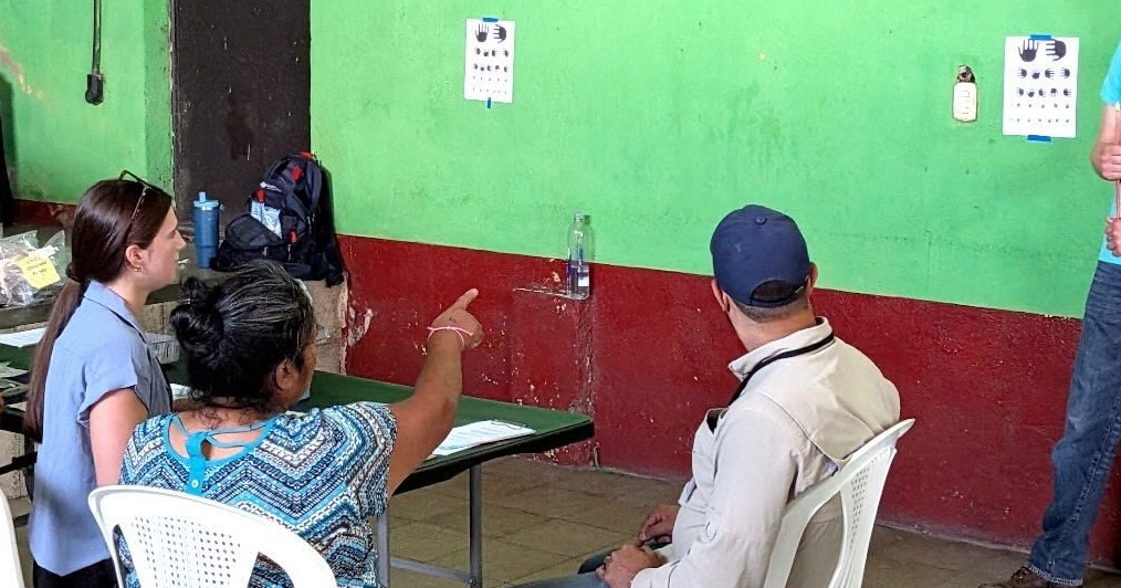 Ferris State Cheer & STUNT student-athlete Julia Priestap helping conduct an eye exam for those served in Guatemala.