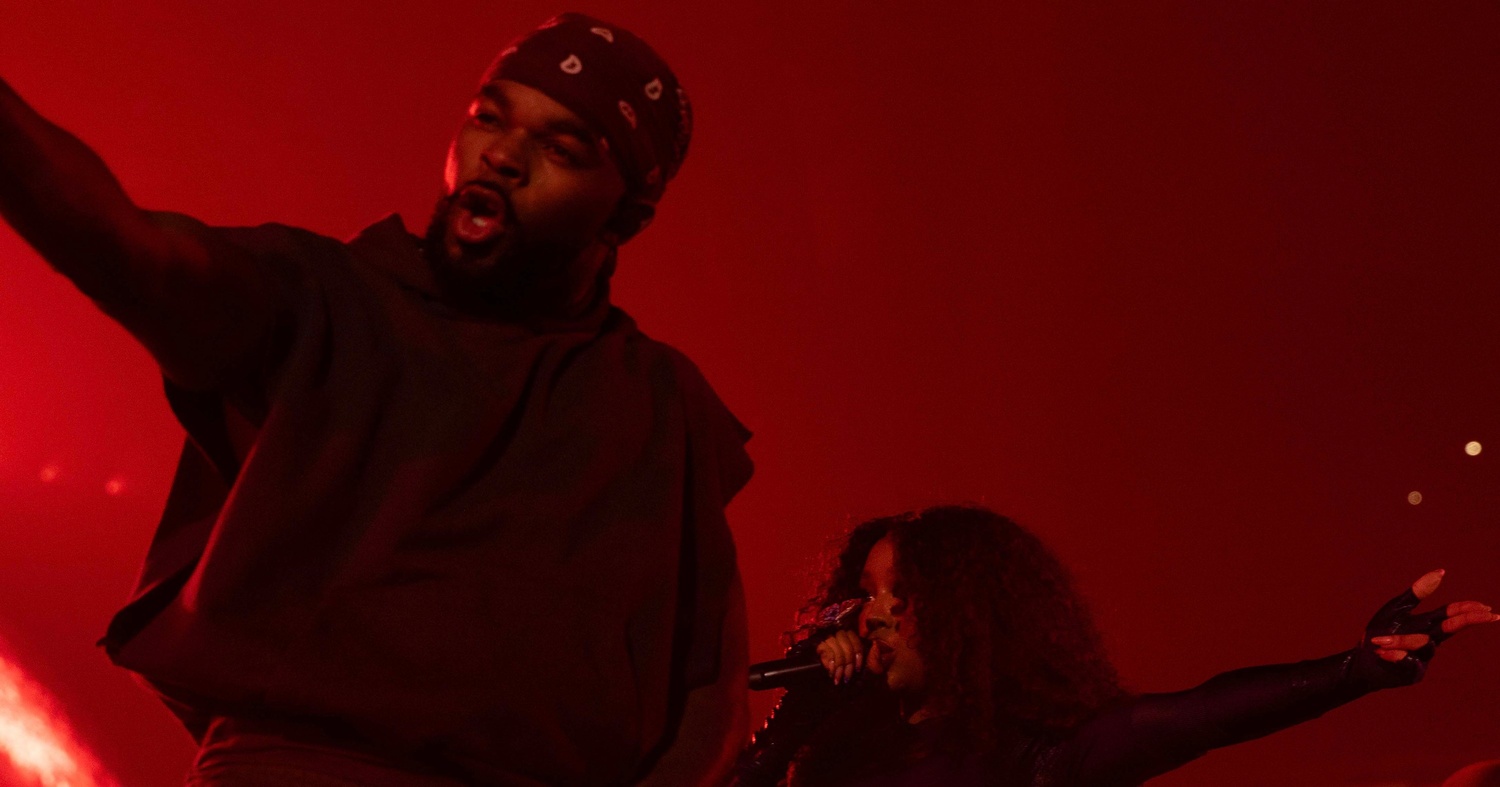 Clark dancing on stage with multi-platinum selling R&B artist SZA