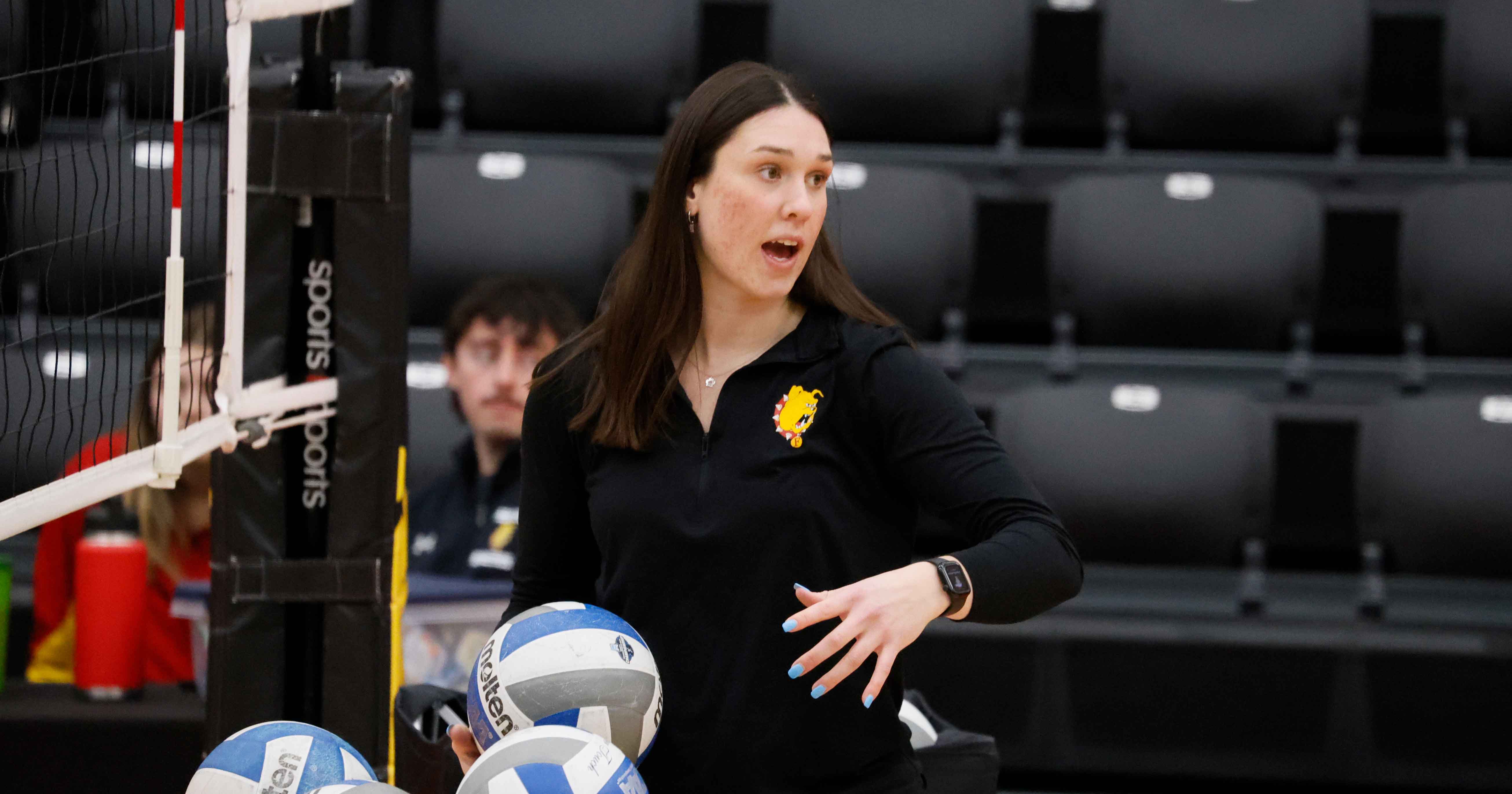 Bleecher helping coach volleyball