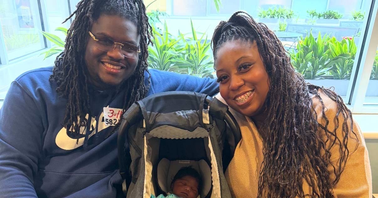 Floyd Breham (right), baby Ferris (middle), and Jamela Bradley (left) posing for a photo