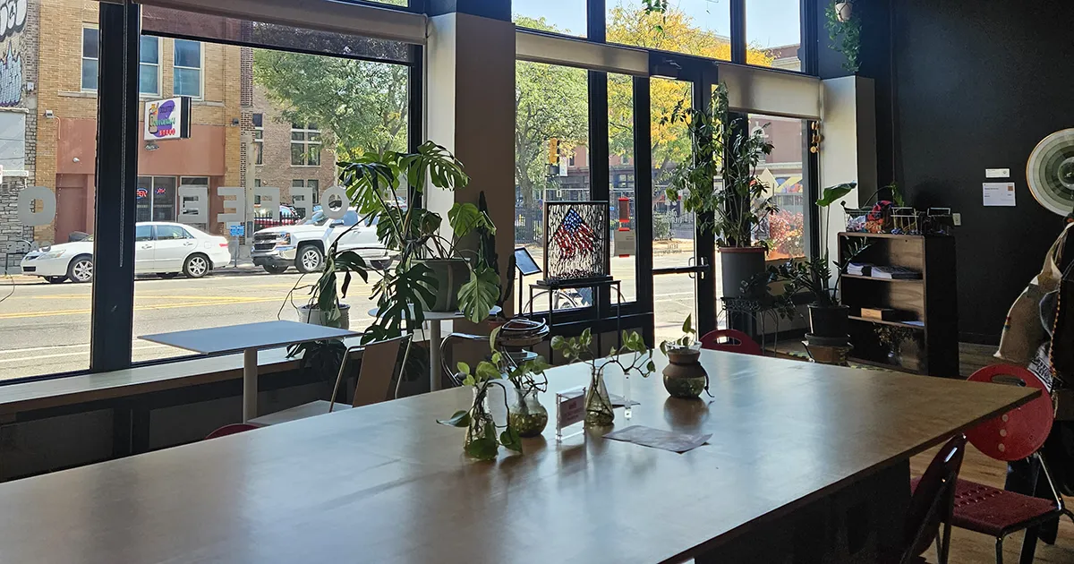 a table with plants looking out onto a city street