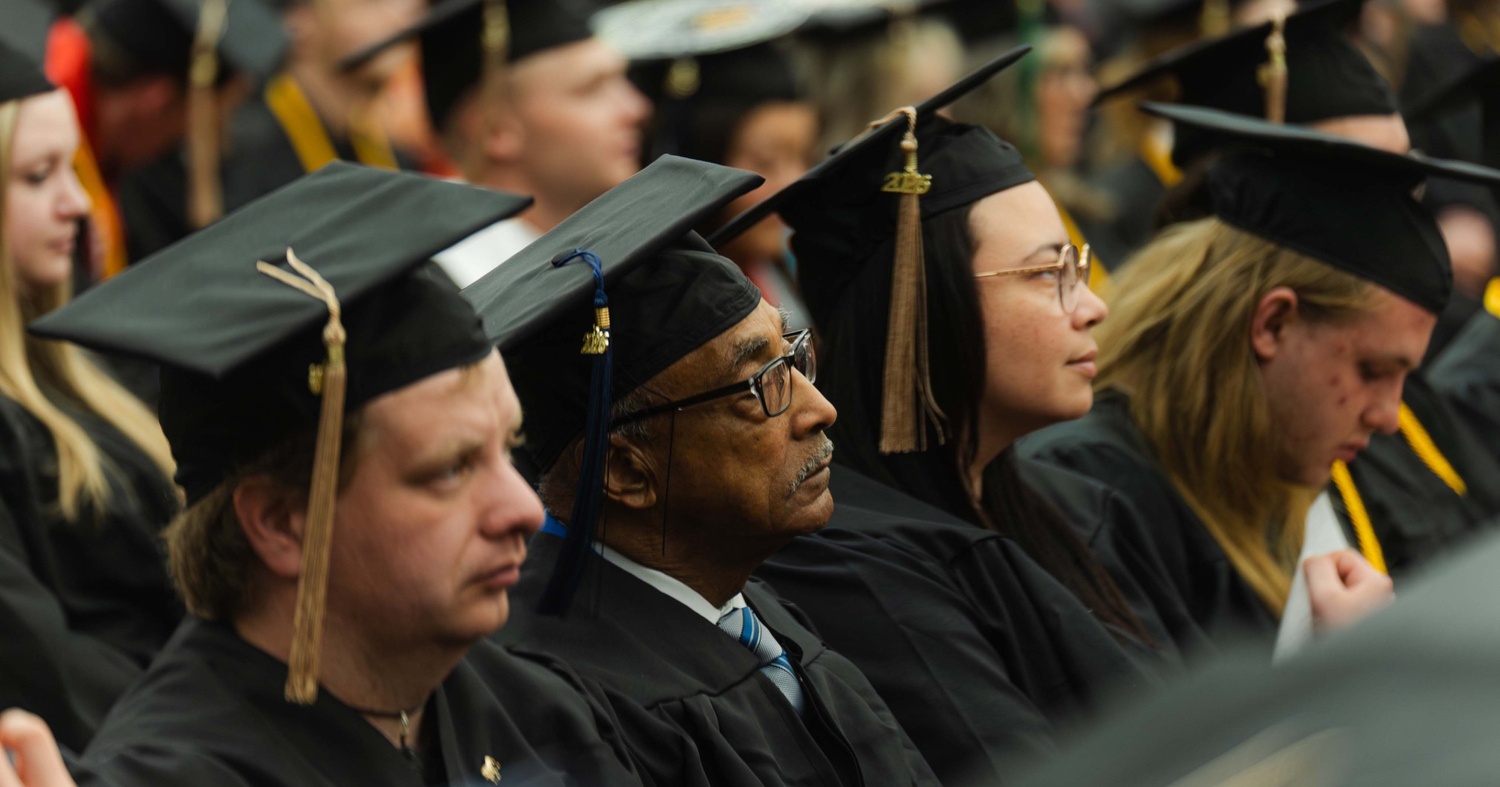 Harris listening closely to speeches during commencement