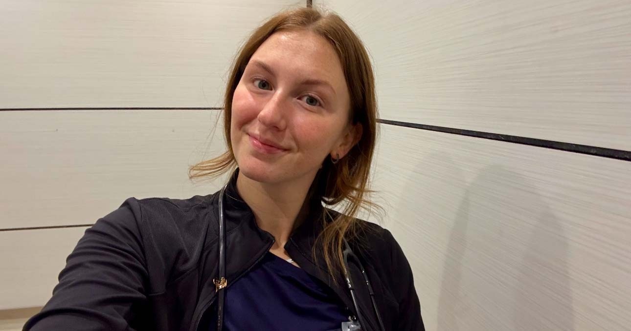 Olivia taking a selfie while wearing her nursing scrubs uniform