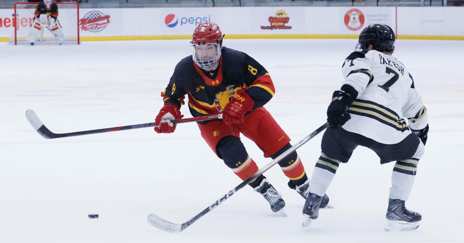 Tyler Schleppe directing the puck past a defenseman