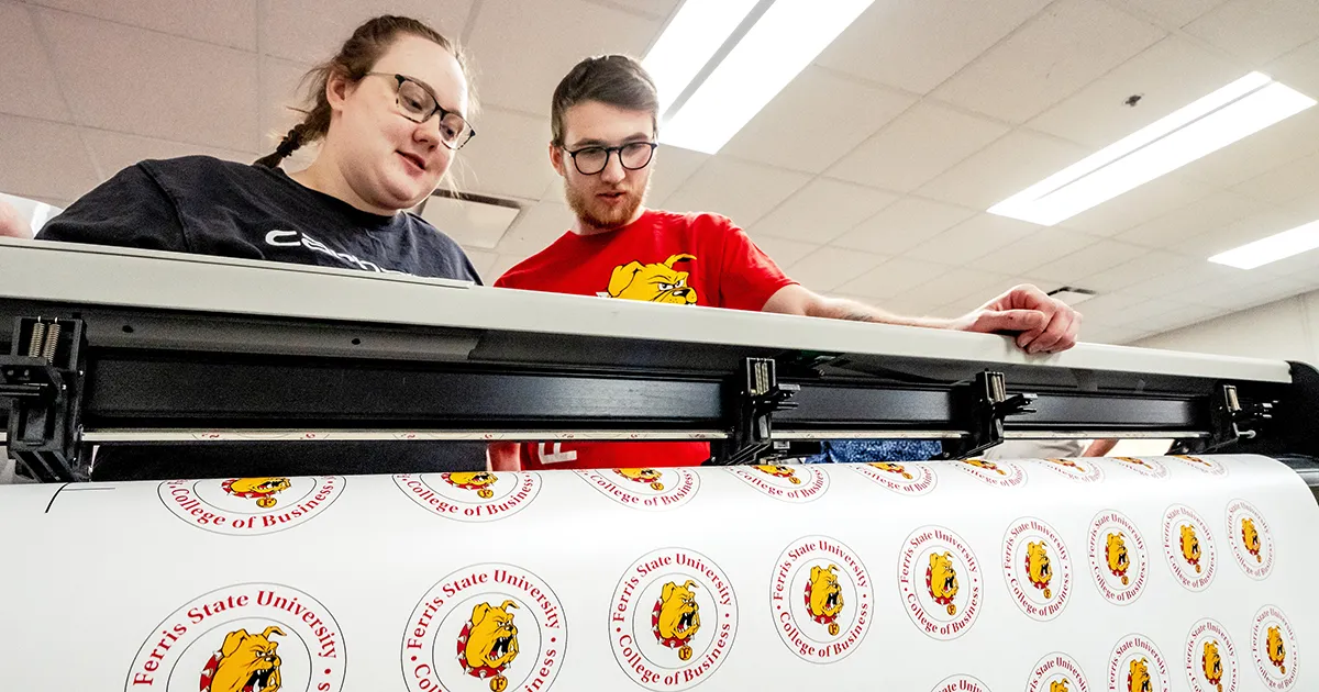 students using a large scale printer