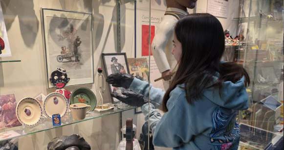 Volunteer pulling an item from display