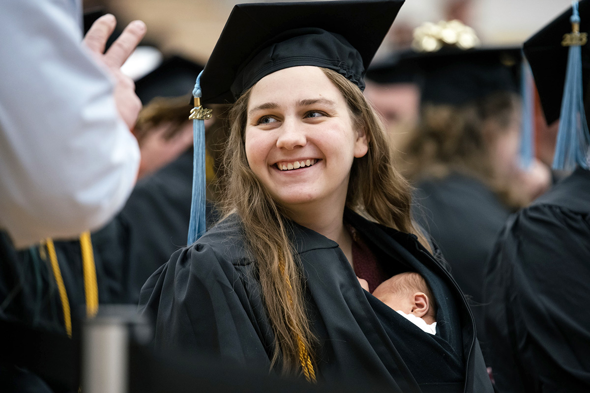 Grace Szymchack and her newborn at commencement ceremonies on the campus of Ferris State University in Big Rapids, Michigan.