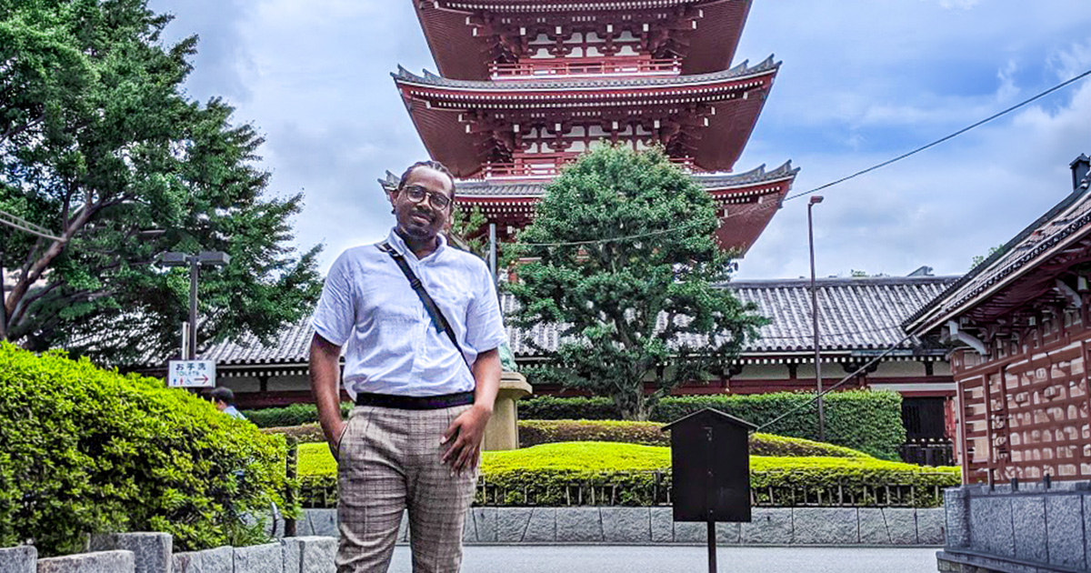 Ferris State University study abroad student studying in South Korea standing in front of historical architecture