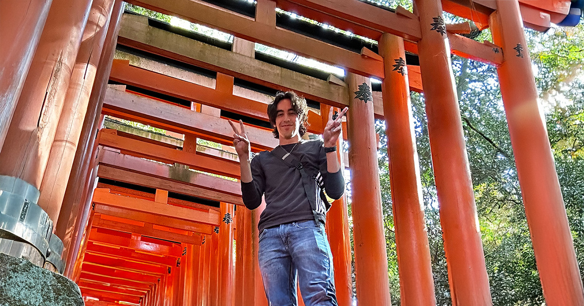 ferris state university student studying abraod in japan standing next to a tori gate in Japan