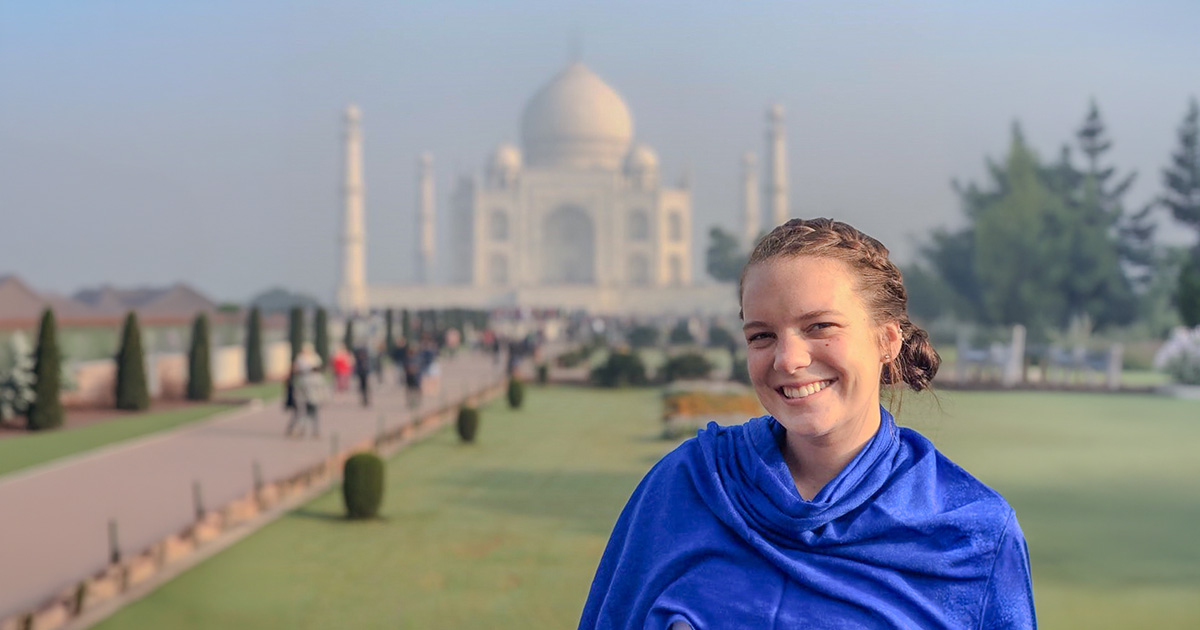 Ferris State University study abroad semester at sea student standing in front of the Taj Mahal