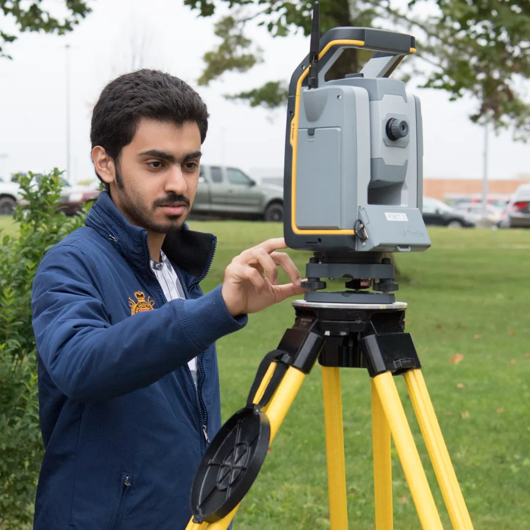 Student using surveying equipment
