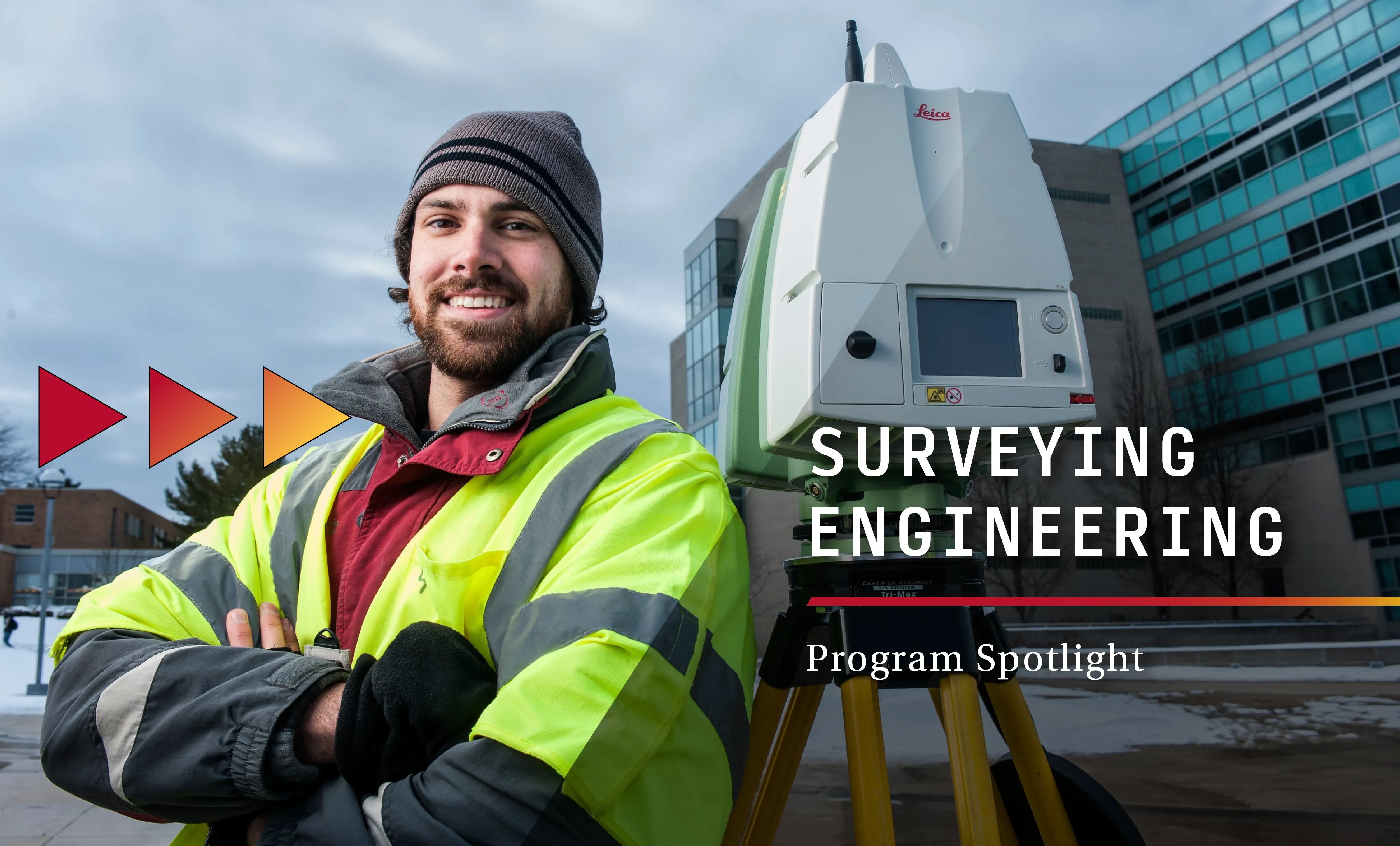 student standing next to surveying equipment
