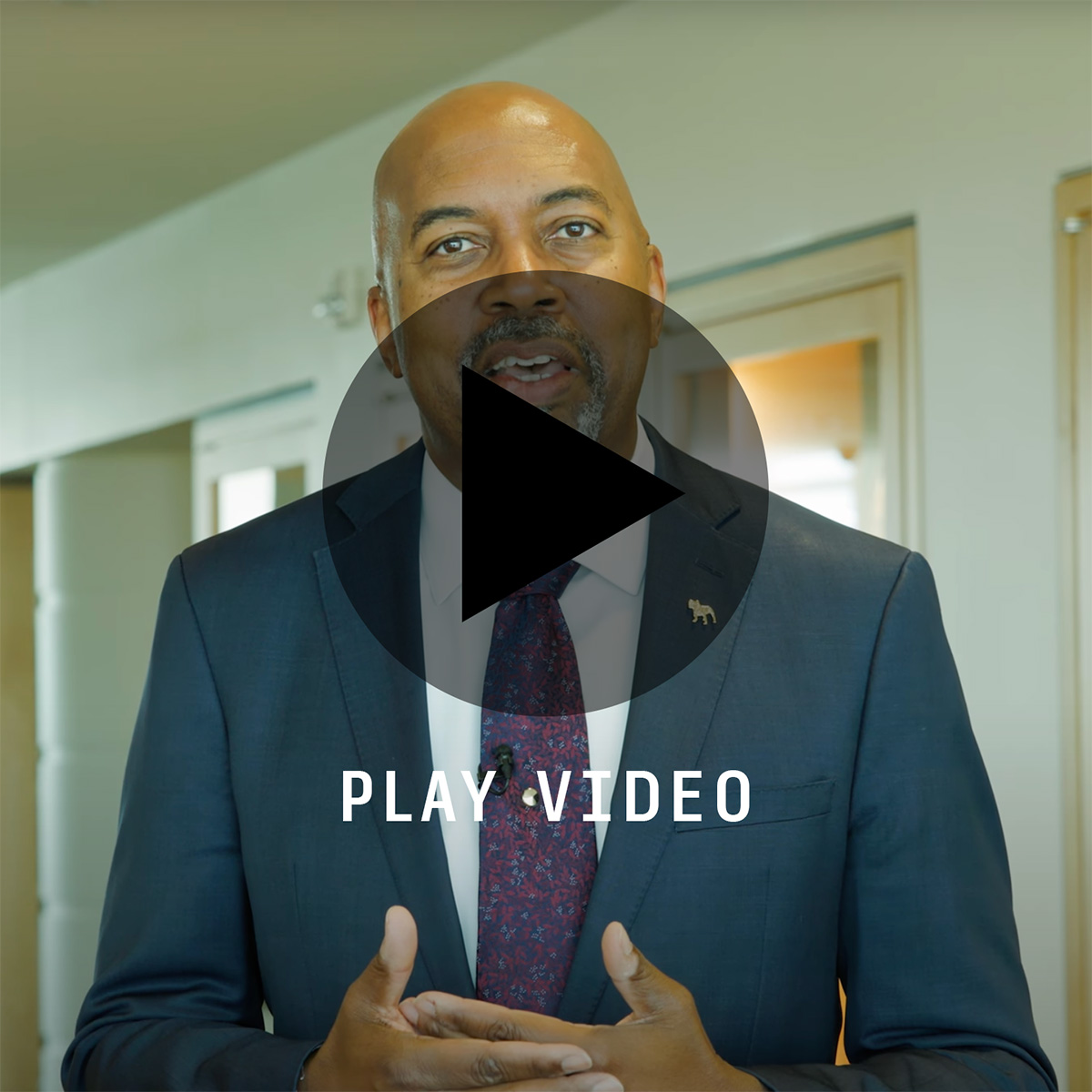 President Bill Pink image with play button overlay