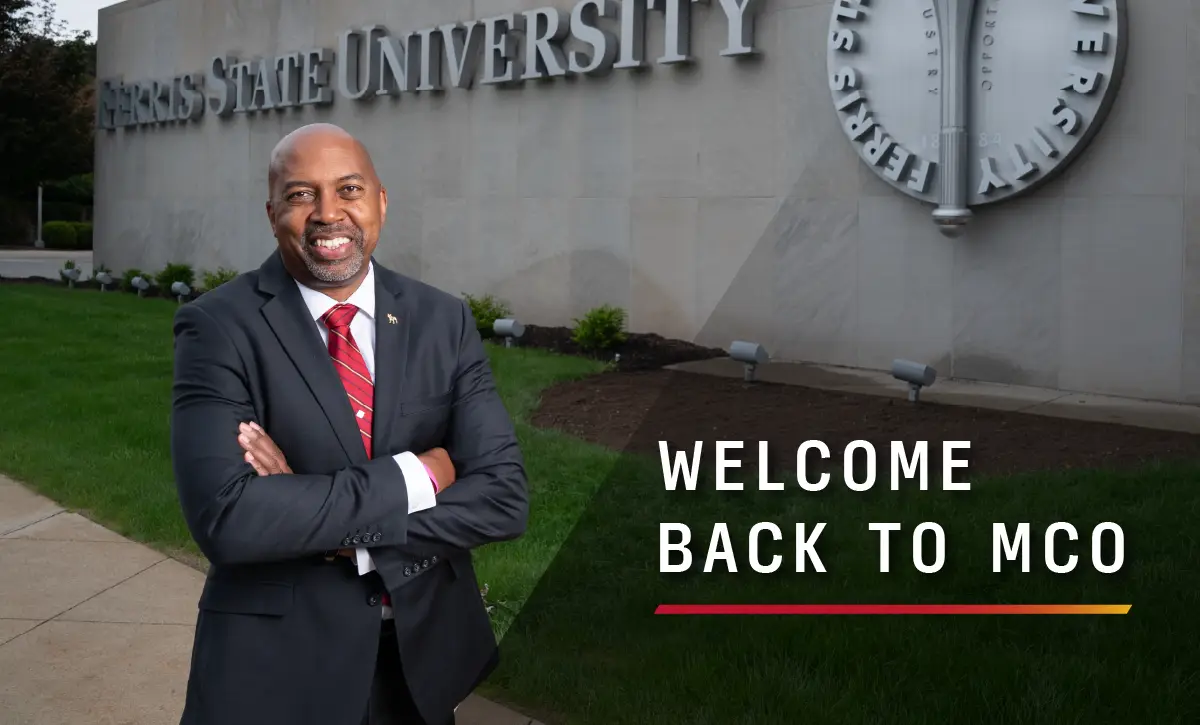 President Bill Pink standing in front of the Ferris State University monument sign, text overlay reads Welcome Back to MCO