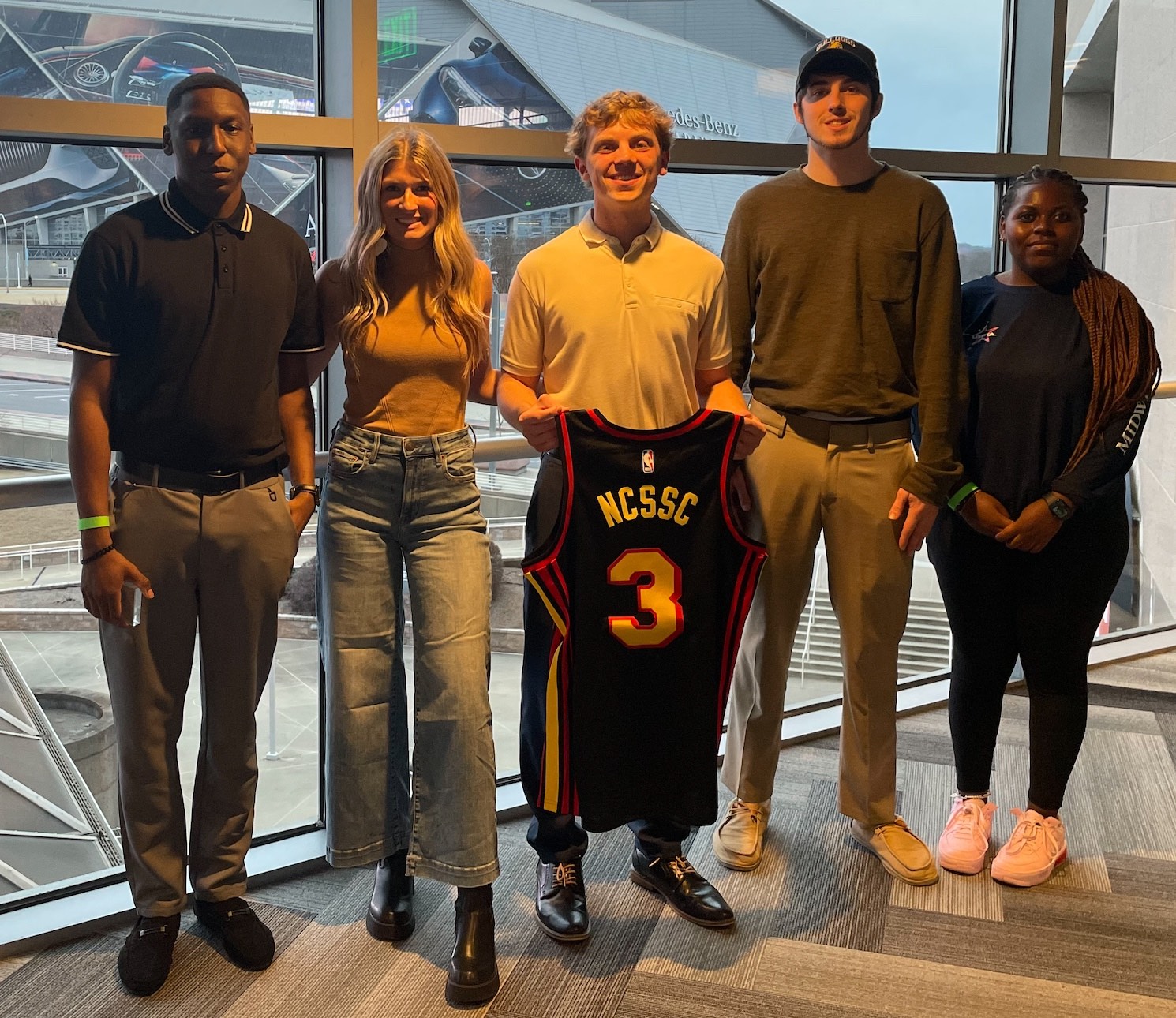 Students standing with NCSSC jersey