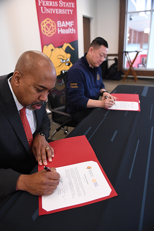 President Pink and BAMF Health CEO Dr. Anthony Chang signing agreement