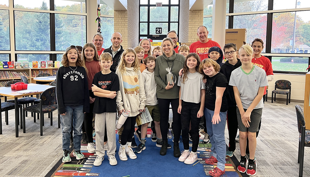 A grant recipient posting with students at Rockford Public Schools.