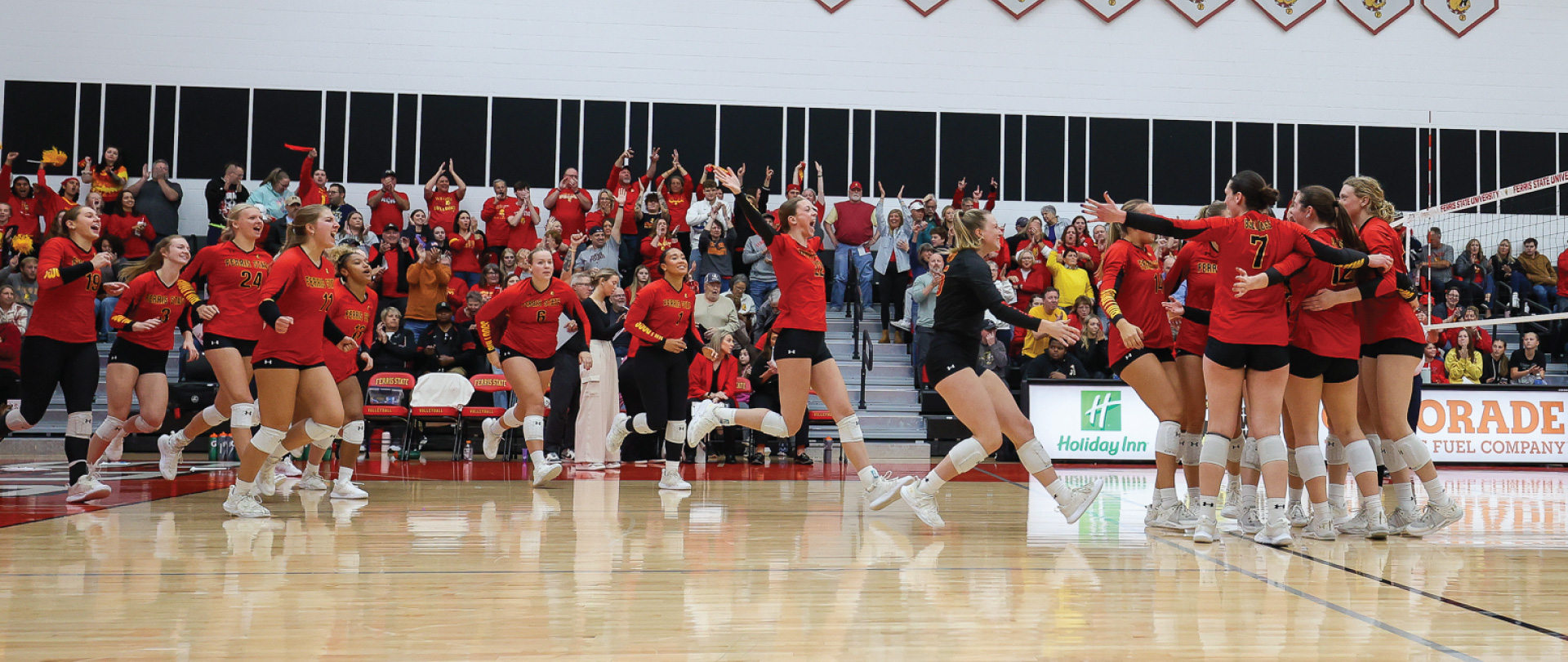 Ferris State volleyball team celebrating after a win