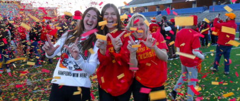 students celebrating on a football field