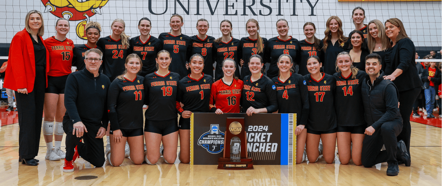 volleyball team photo in front of volleyball court