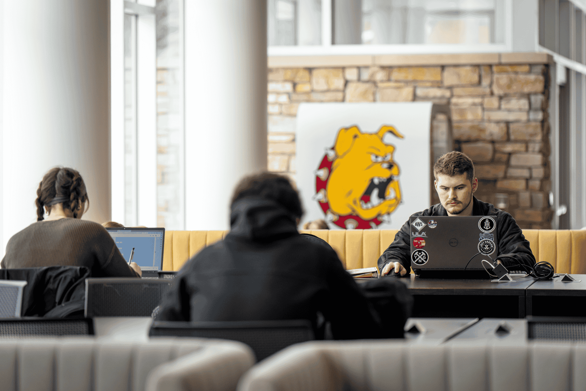 student at desk looking at computer