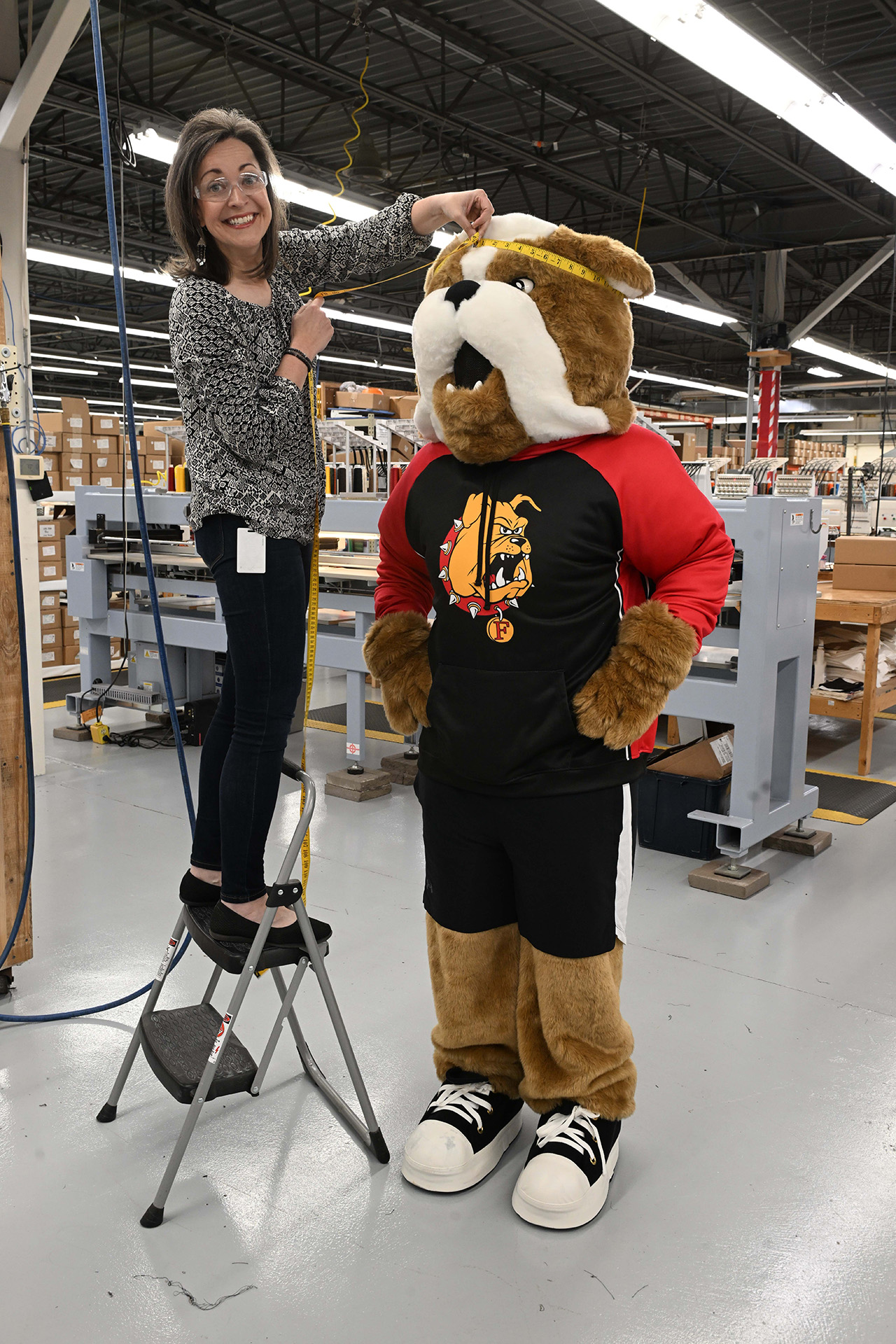 CEO Gina Jacquart Thorson fits Brutus for his special Stormy Kromer cap