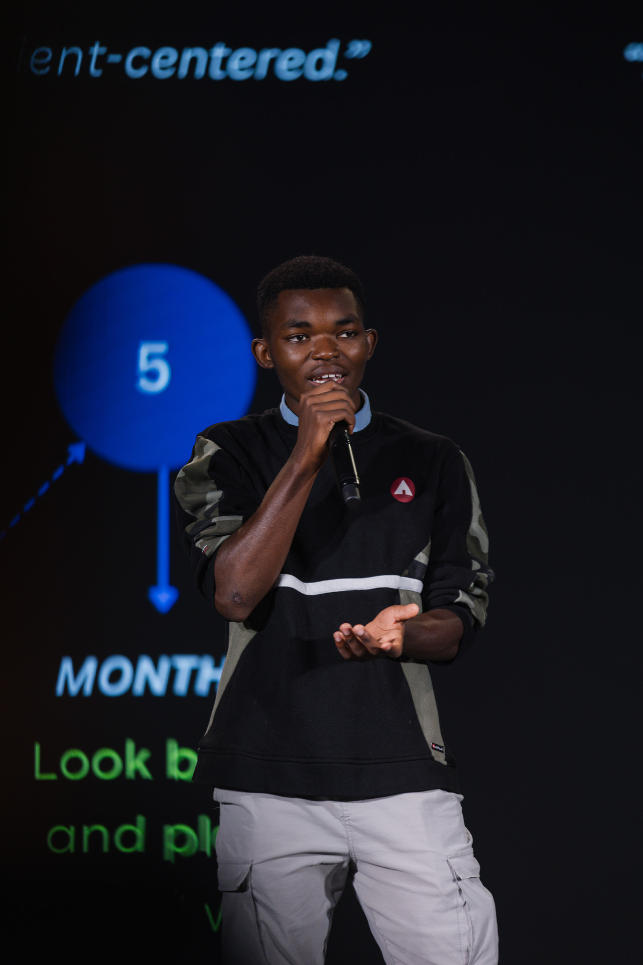 Kellogsville High School student Baruani Amisi and team presenting at the FutureSolve 2025 final event