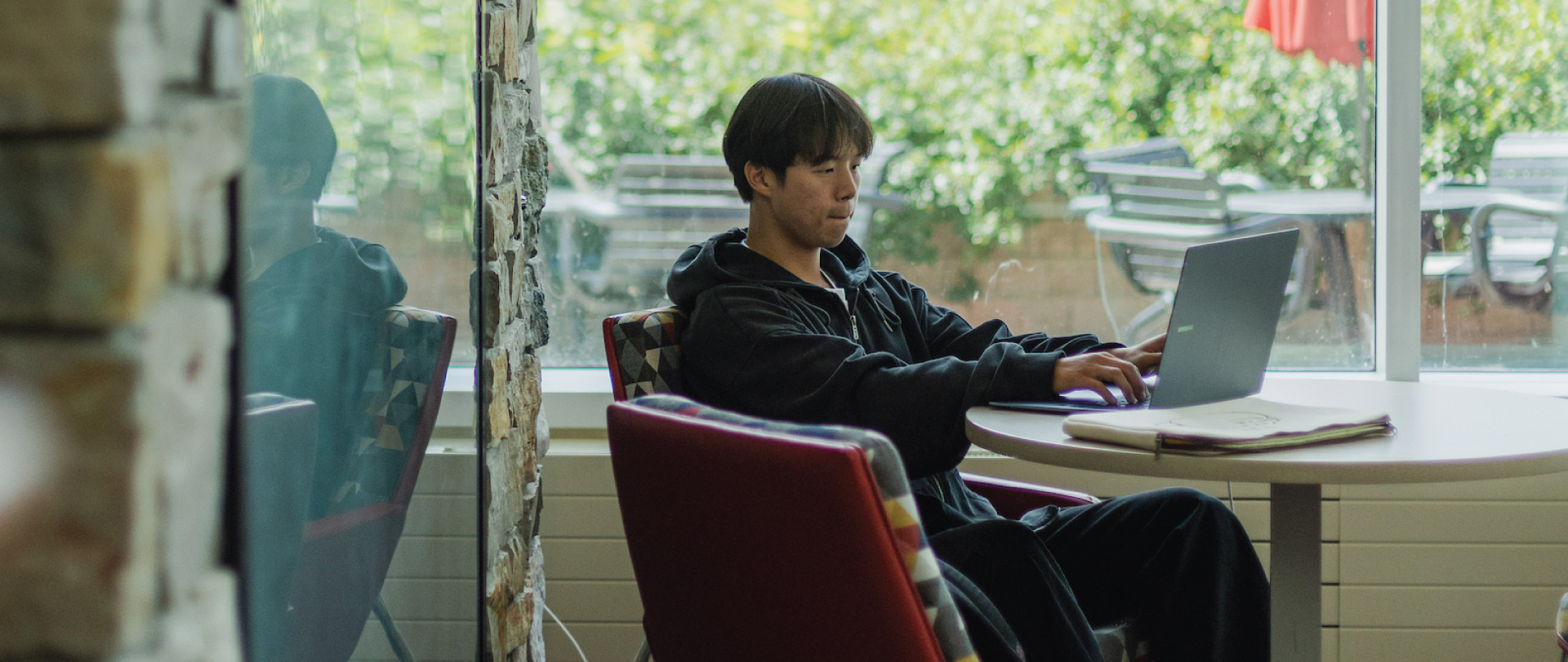 Student on laptop in DEC on campus