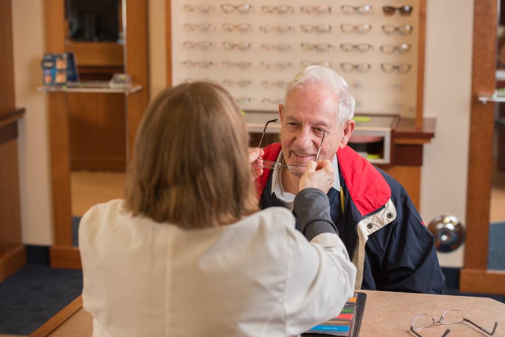 Optician adjusting glasses