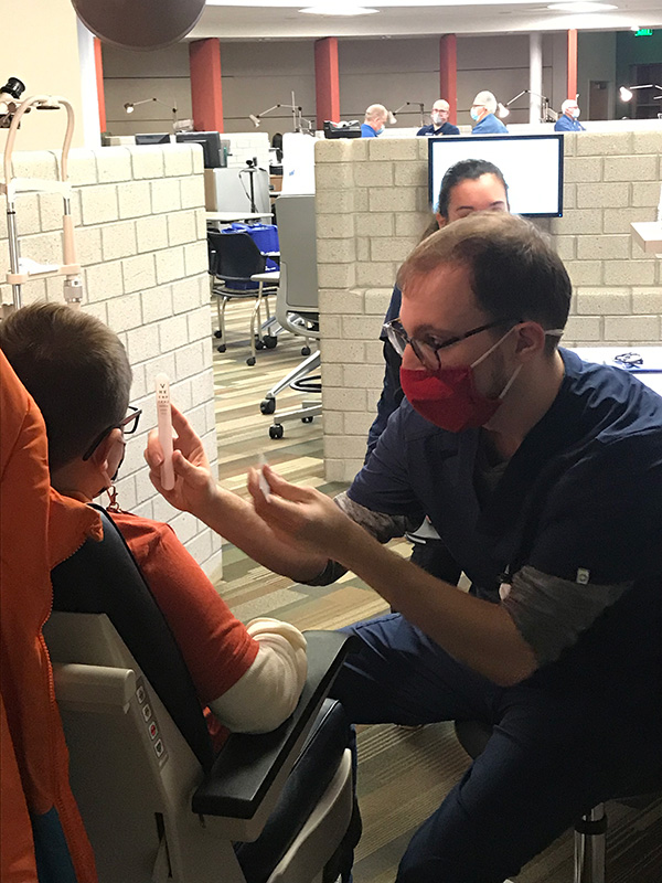 MCO student completing eye exam